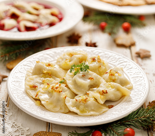 Dumplings with mushroom cabbage filling on a white plate. Vegetarian food, Traditional Christmas eve dish in Poland photo