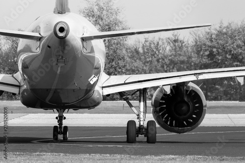 Aircraft waiting for permission to take off, rear view, black and white
