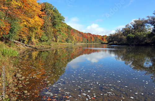 The Grand River with the fall colours reflecting in it. Shot in Kitchener, Ontario, Canada.