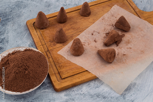 Sweet dessert - chocolate truffles sprinkled with cocoa powder.