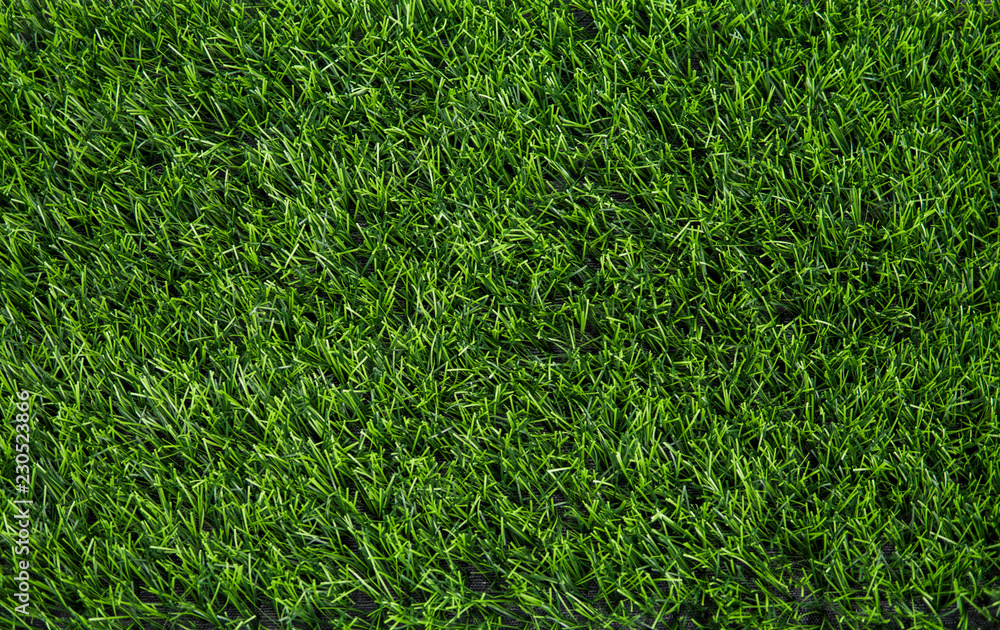 Artificial green grass texture background top view.