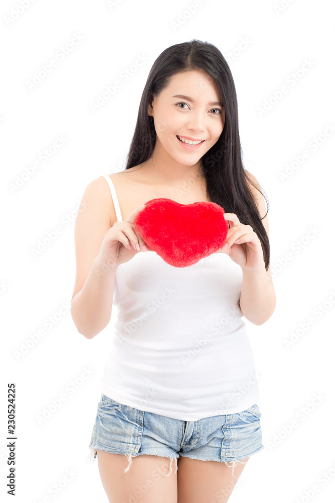 Portrait of beautiful asian young woman holding red heart shape pillow and smile isolated on white background, valentines day, holiday concept. Portrait of beautiful asian young woman holding red heart shape pillow and smile isolated on white background, valentines day, holiday concept.