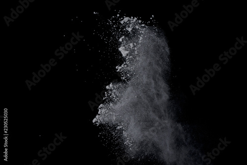 Fototapeta Naklejka Na Ścianę i Meble -  White powder explosion on black background. Dust splatted isolated. Paint Holi.