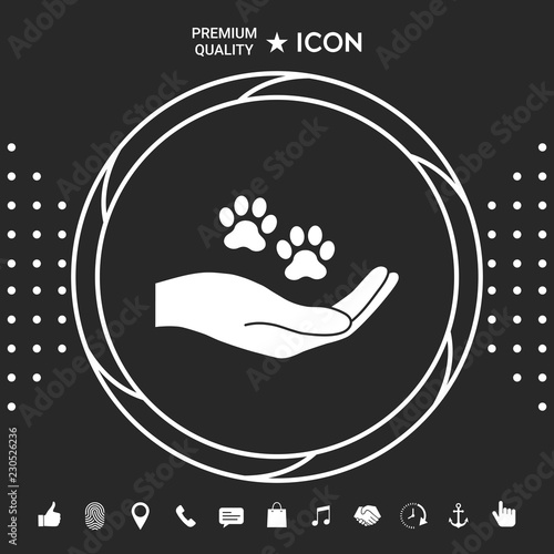 Hand holding paw symbol. Animal protection