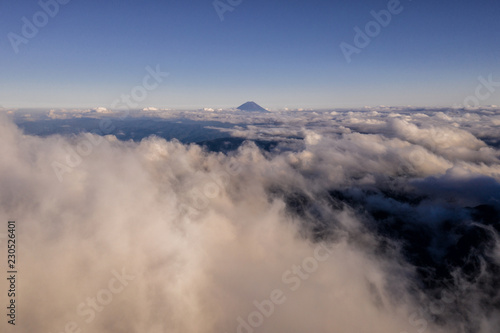 Aerial drone photo - Volcano Mt. Fuji rising above an ocean of clouds.  Mountain in Japan