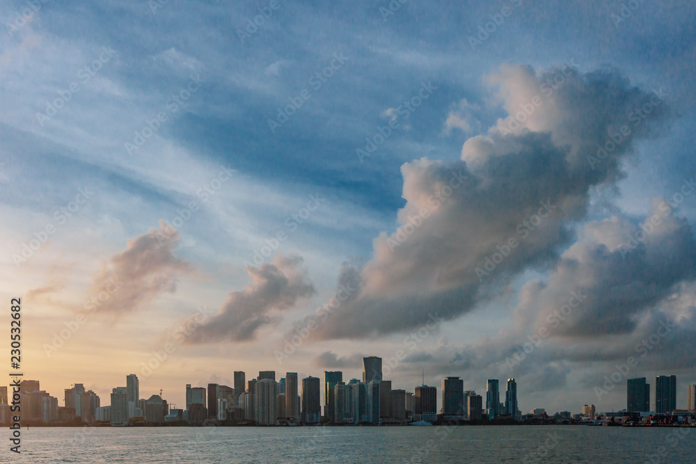 Skyline of downtown Miami from the sea under sky and clouds at sunset, in Florida, USA