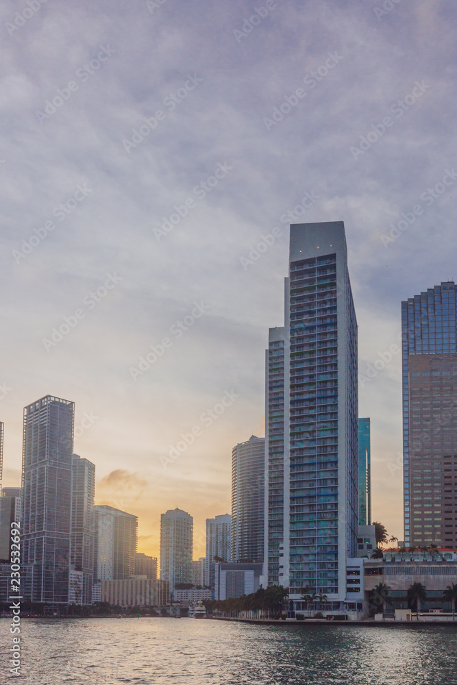 Buildings by water in the Biscayne Bay of Miami, Florida, USA, at sunset
