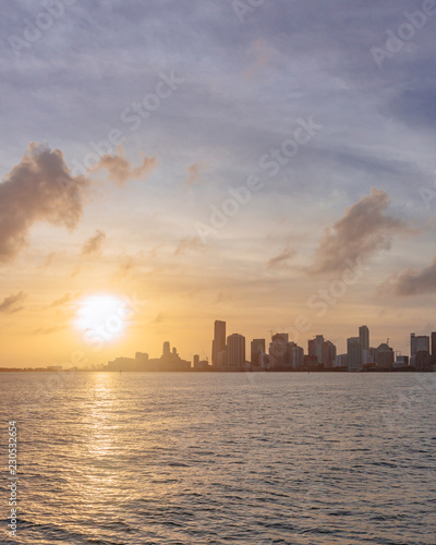 Skyline of downtown Miami from the sea under sky and clouds at sunset, in Florida, USA © Mark Zhu