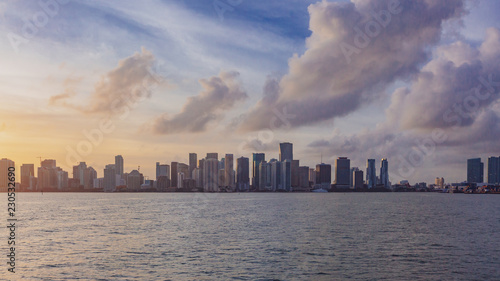 Skyline of downtown Miami from the sea under sky and clouds at sunset, in Florida, USA © Mark Zhu
