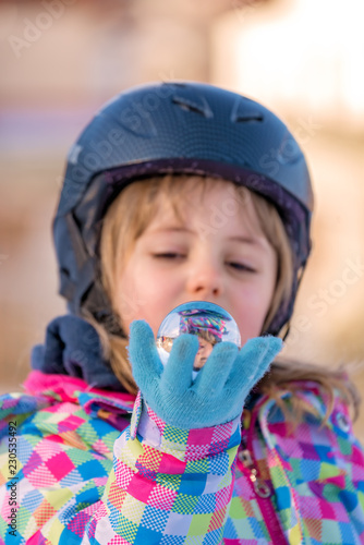 Ski girl holding glass ball