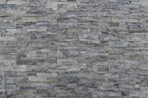 Gray slate wall stone background. horizontal modern brick wall for wallpaper and background.