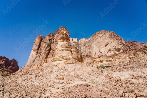 Red mountains of Wadi Rum desert in Jordan. Wadi Rum also known as The Valley of the Moon is a valley cut into the sandstone and granite rock in southern Jordan to the east of Aqaba