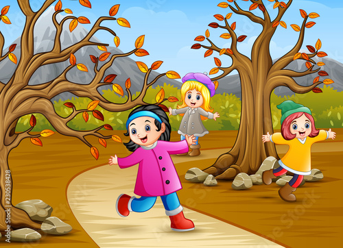Happy kids playing in the autumn park