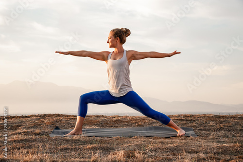 young woman doing yoga warrior pose