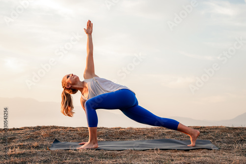 Fit Woman Doing Reaching Yoga Pose at Sunset