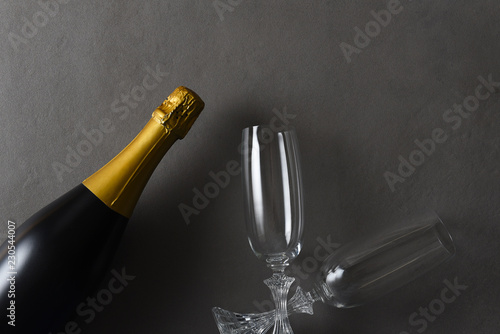 Flat lay Champagne and two glasses on a dark gray table
