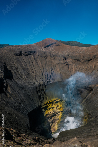The crater of the volcano Gunung Bromo (called Eye of Bromo). View from the observation deck on the edge of the crater. Bromo Tengger Semeru National Park. Indonesia
