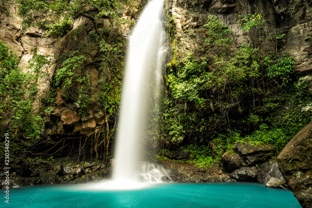 Majestic waterfall in the rainforest jungle of Costa Rica.  La Cangreja waterfall in Rincon de La Vieja National Park, Guanacaste - obrazy, fototapety, plakaty 
