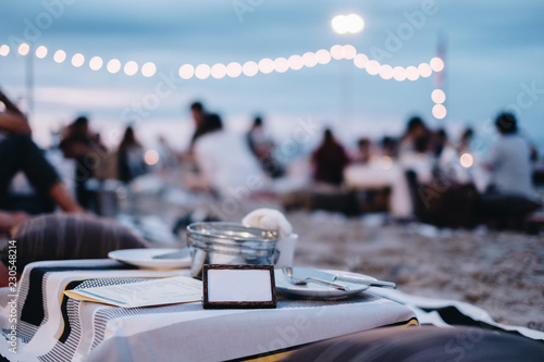 Fototapeta Naklejka Na Ścianę i Meble -  Seafood Dinner at restaurant view on night beach . Image has vintage effect, Grain and noise was added