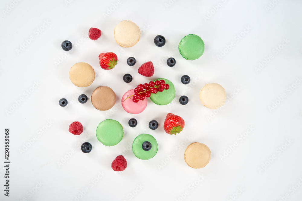 macaroons on white background with berries top view macaroons on white background with berries top view
