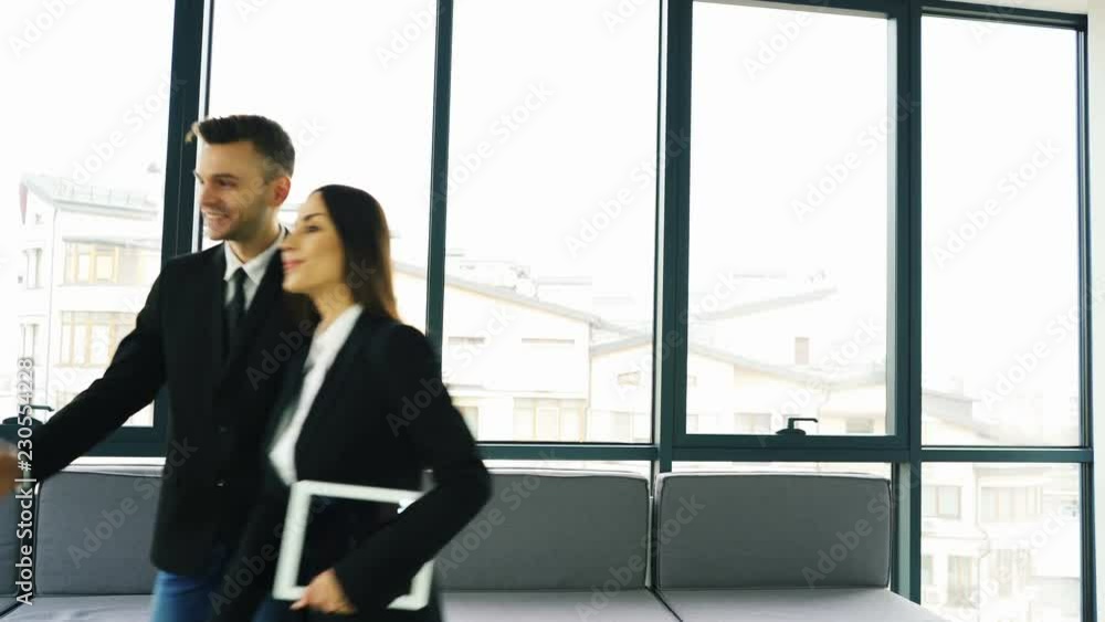 4K. Office work meeting. Two business partner, man and woman, shake hands and smile 4K. Office work meeting. Two business partner, man and woman, shake hands and smile