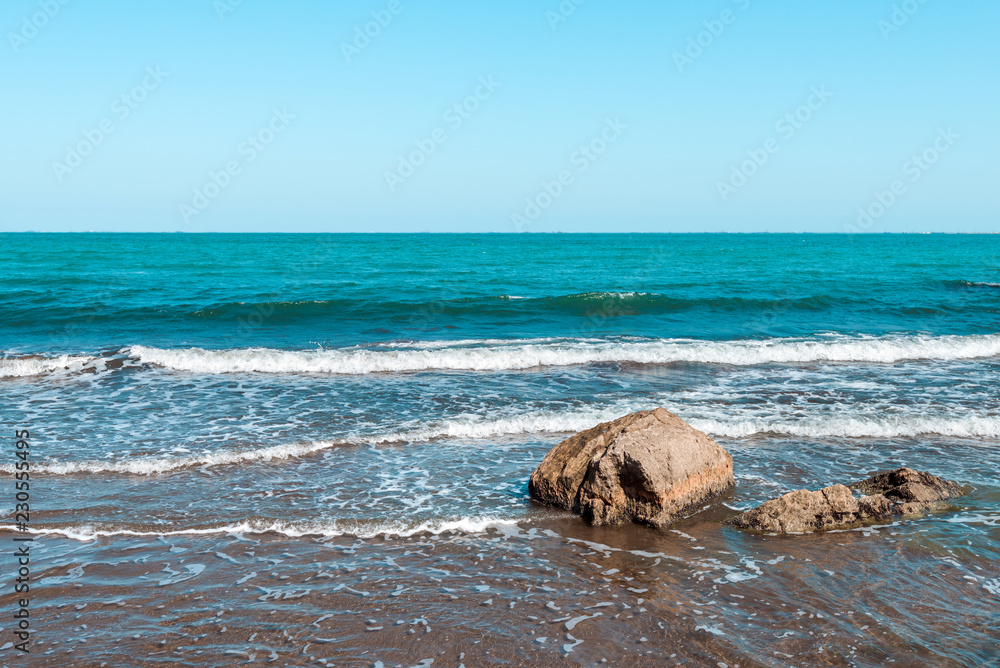 Rocky sea coast with turquoise water on the beach Rocky sea coast with turquoise water on the beach