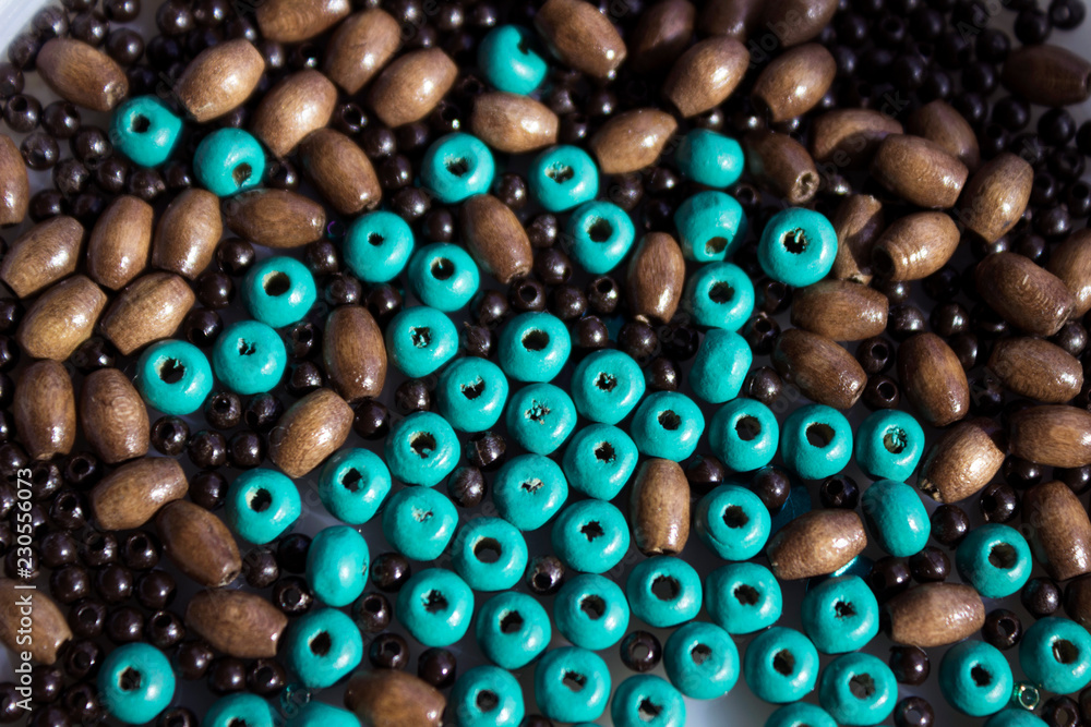 Brown and turquoise wooden beads background. Handmade
