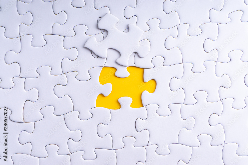 White jigsaw puzzle with selective focus and crop fragment