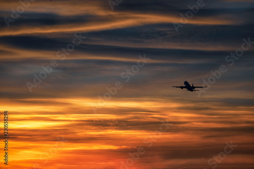 Silhouette plane take off in beautiful sky