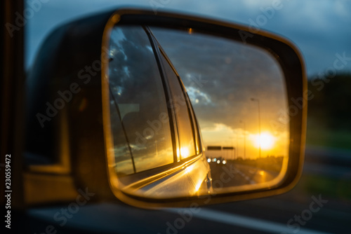 car on highway. sunset in car mirror reflection © phpetrunina14
