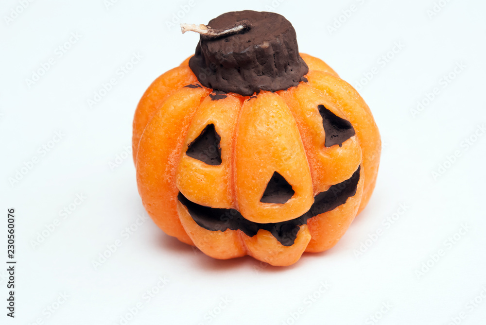 Decorative candle in the form of a pumpkin for Halloween Decorative candle in the form of a pumpkin for Halloween