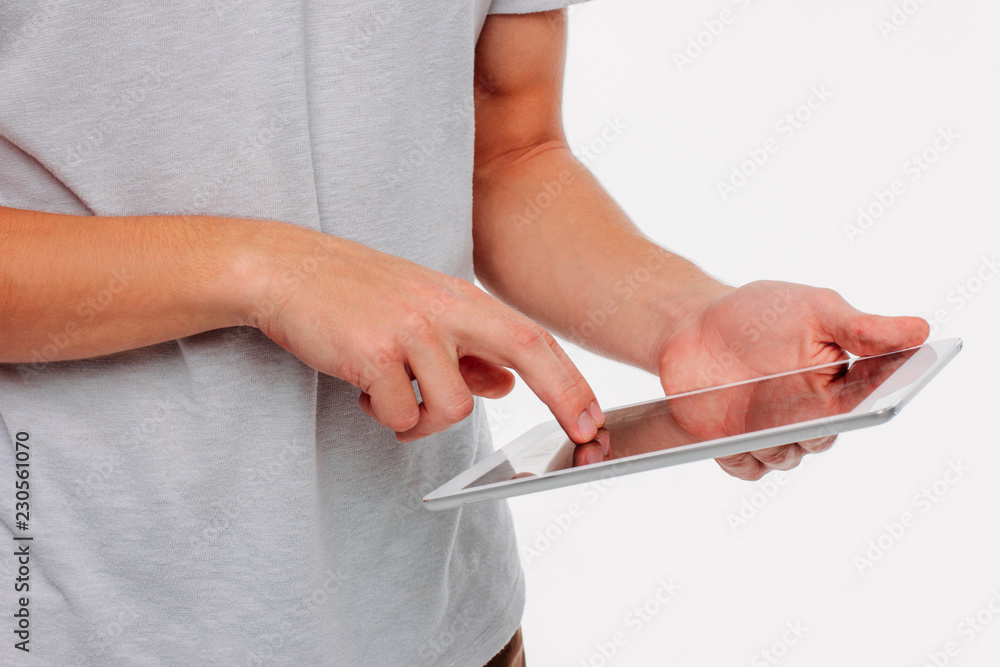 Tablet in men's hands on a white background, close up