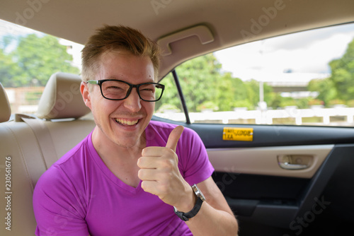 Young handsome tourist man inside the car around the city of Ban © Ranta Images