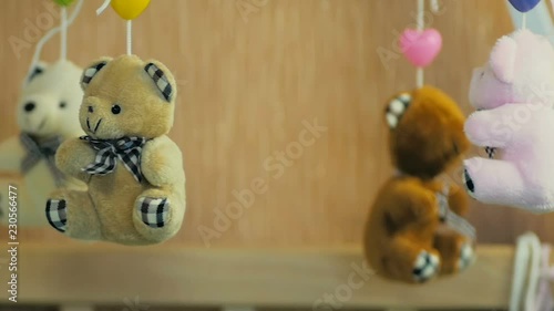 Close-up of a teddy bears on a children carousel as a symbol of childhood in slow motion.
