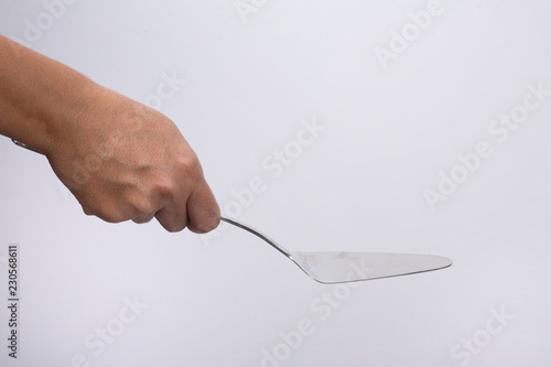 Woman hand holding a spatula