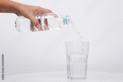 Hand Pouring water from a bottle in to a glass