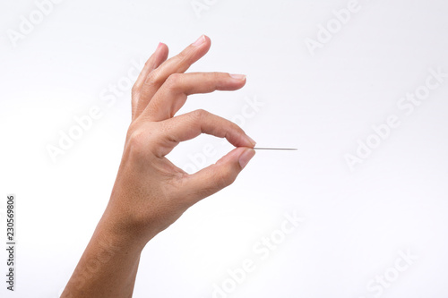 The hand holding the toothpick. Close up. Isolated on white background photo