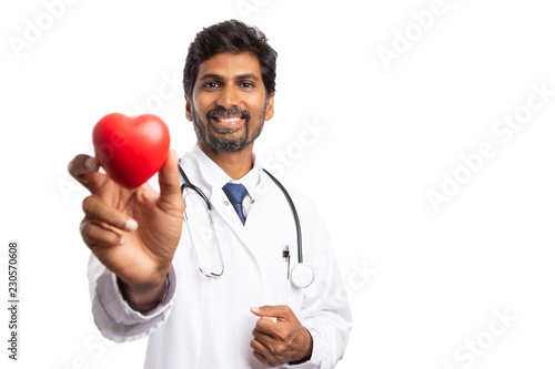 Doctor holding unfocused heart shape. photo