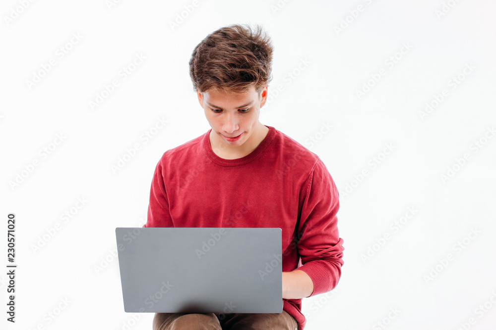 Teenager student working at laptop on white background Teenager student working at laptop on white background