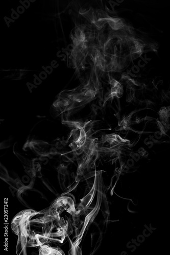 Fototapeta Naklejka Na Ścianę i Meble -  abstract white smoke in the air on a black background
