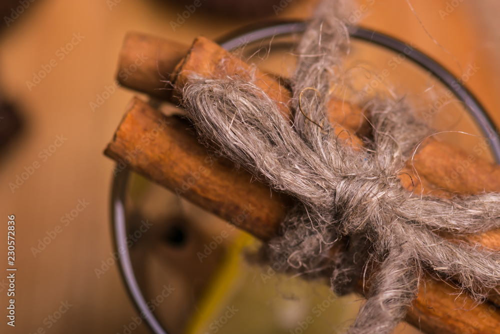 A glass with cinnamon and lemon. A glass with cinnamon and lemon.