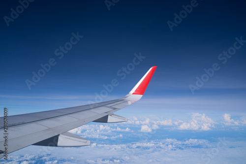 Beautiful view from airplane window and blue sky on nice sunny day, This time in altitude during flight.