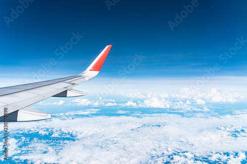 Beautiful view from airplane window and blue sky on nice sunny day, This time in altitude during flight.