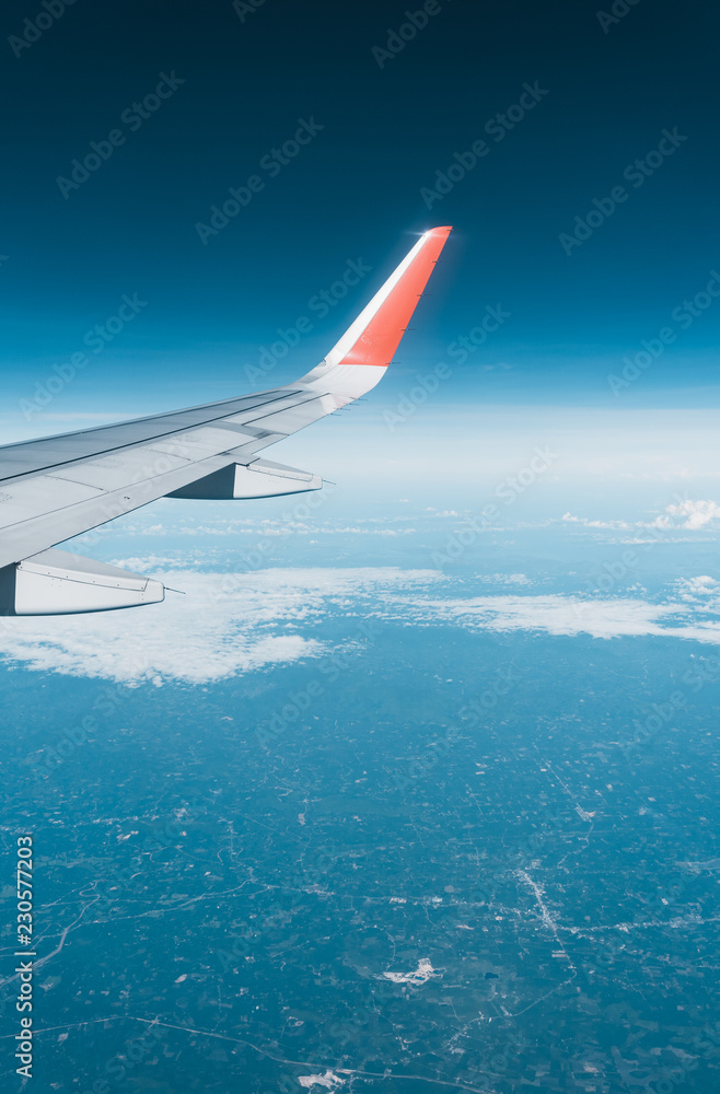 Fototapeta premium Beautiful view from airplane window and blue sky on nice sunny day, This time in altitude during flight.