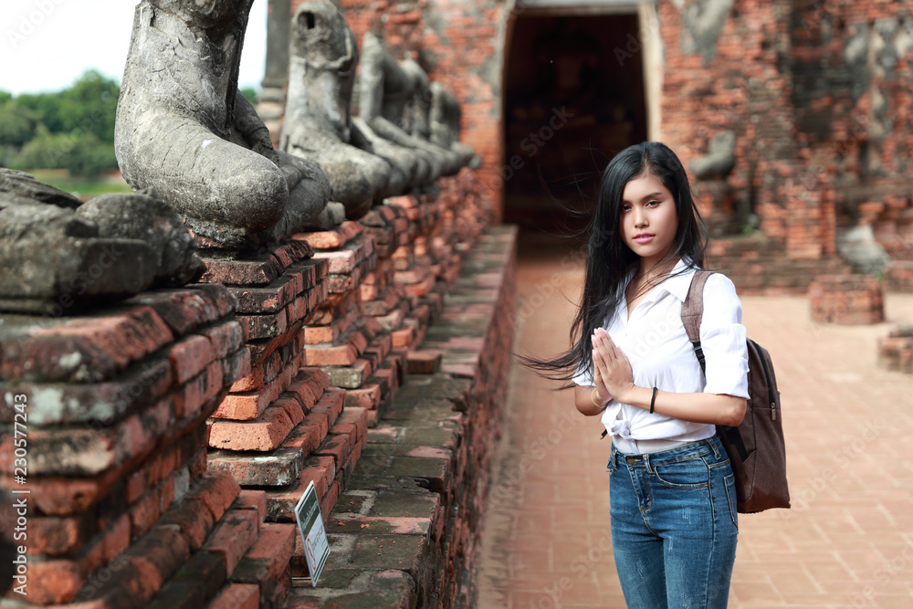 portrait of beautiful traveler asian woman paying respect in ancient temple