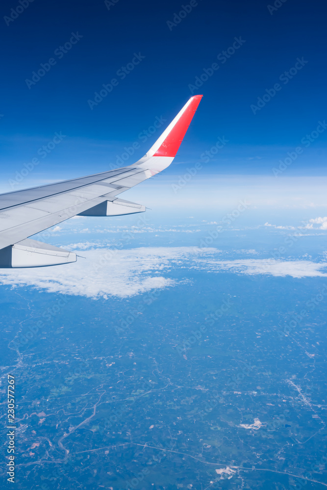 Fototapeta premium Beautiful view from airplane window and blue sky on nice sunny day, This time in altitude during flight.