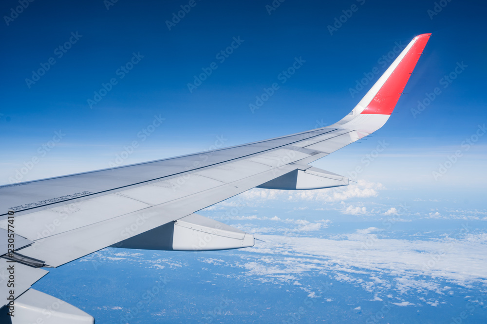 Beautiful view from airplane window and blue sky on nice sunny day, This time in altitude during flight.