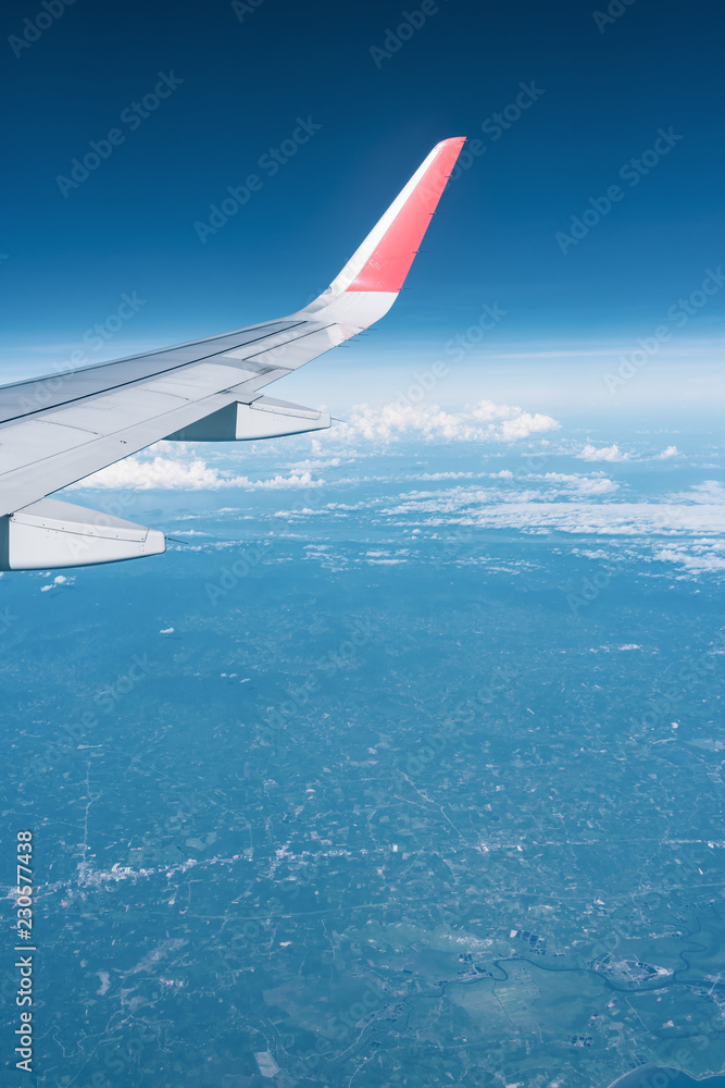 Fototapeta premium Beautiful view from airplane window and blue sky on nice sunny day, This time in altitude during flight.