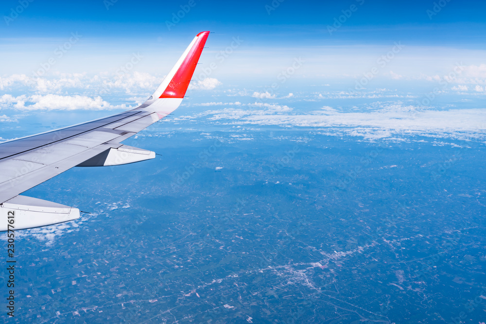 Fototapeta premium Beautiful view from airplane window and blue sky on nice sunny day, This time in altitude during flight.