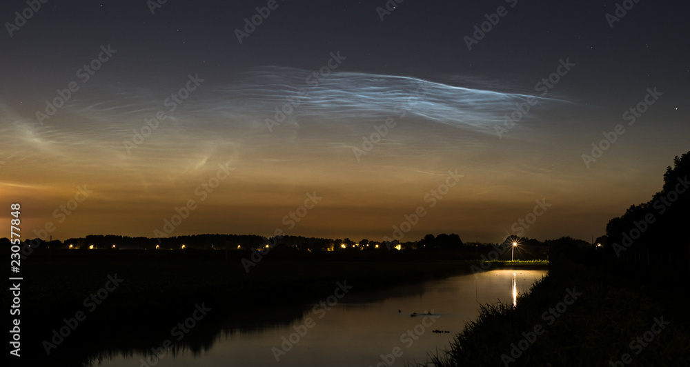 Field of bright noctilucent clouds with nice waves and ripples in the early morning Field of bright noctilucent clouds with nice waves and ripples in the early morning